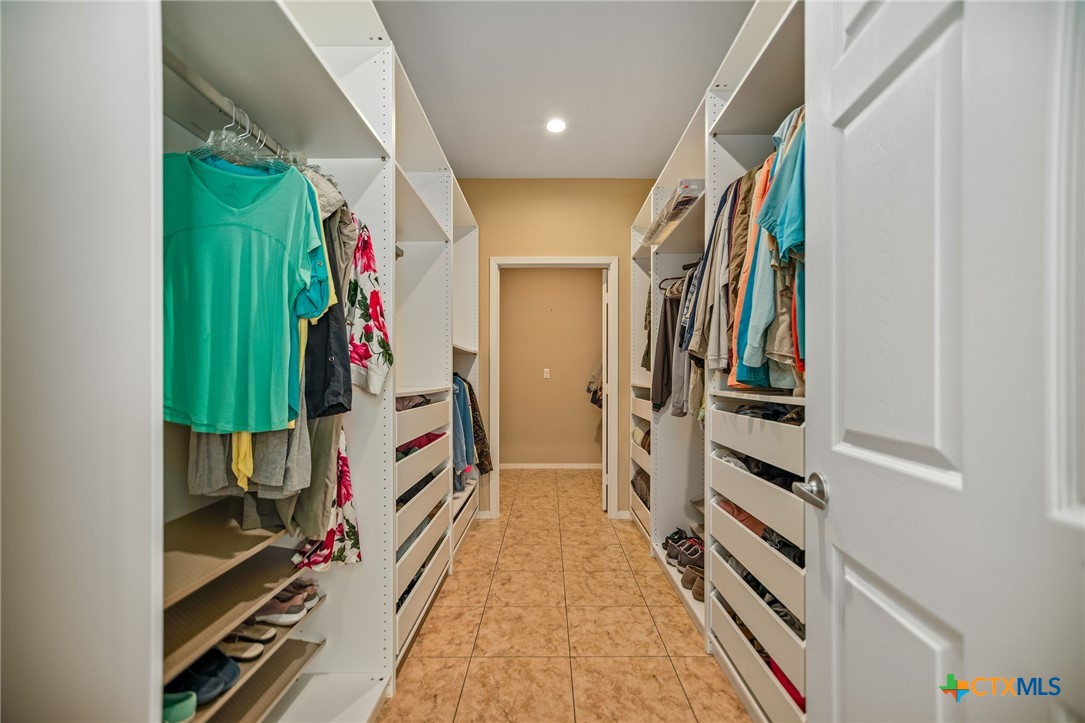 265 Coastal Oaks Loop Port O'Connor, TX 77982 - Photo 34 of 48 a view of walk in closet with clothes and shoes