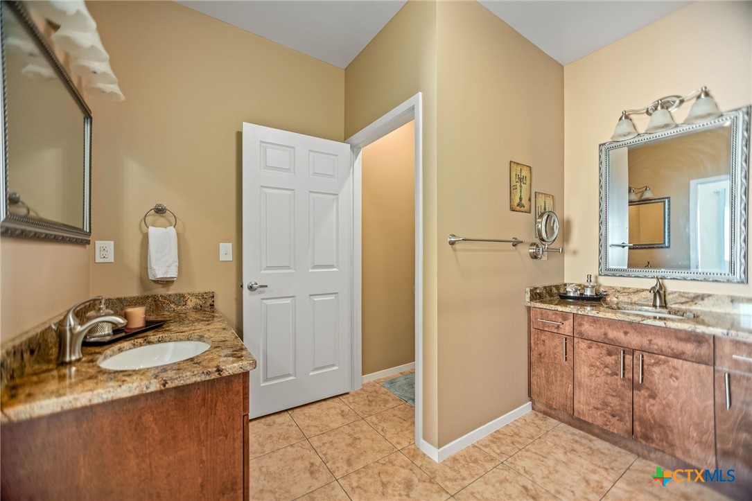 265 Coastal Oaks Loop Port O'Connor, TX 77982 - Photo 36 of 48 a bathroom with a granite countertop sink and a mirror