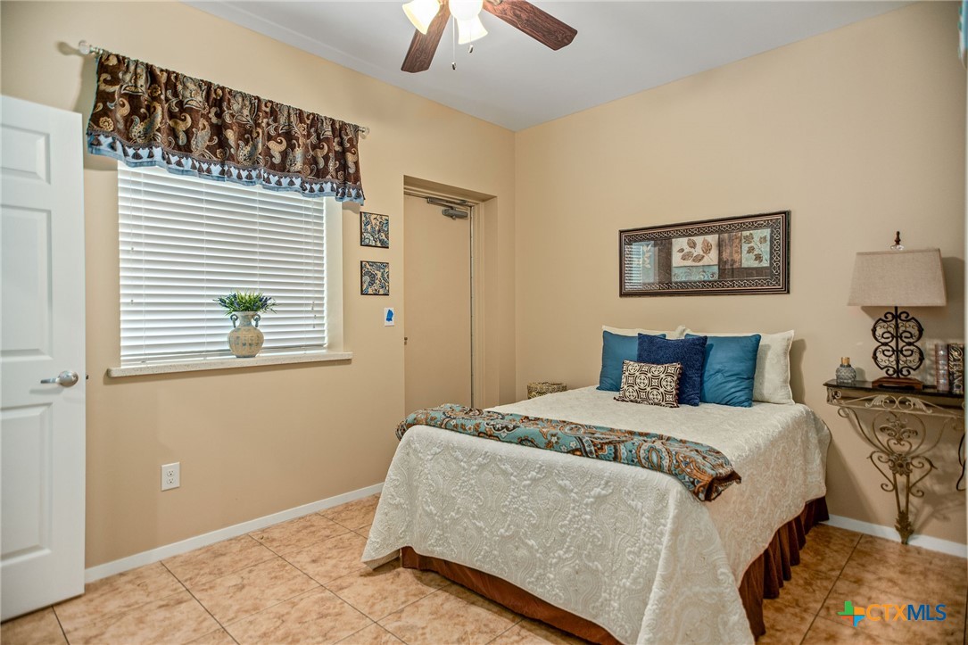 265 Coastal Oaks Loop Port O'Connor, TX 77982 - Photo 39 of 48 a bedroom with a bed and a window