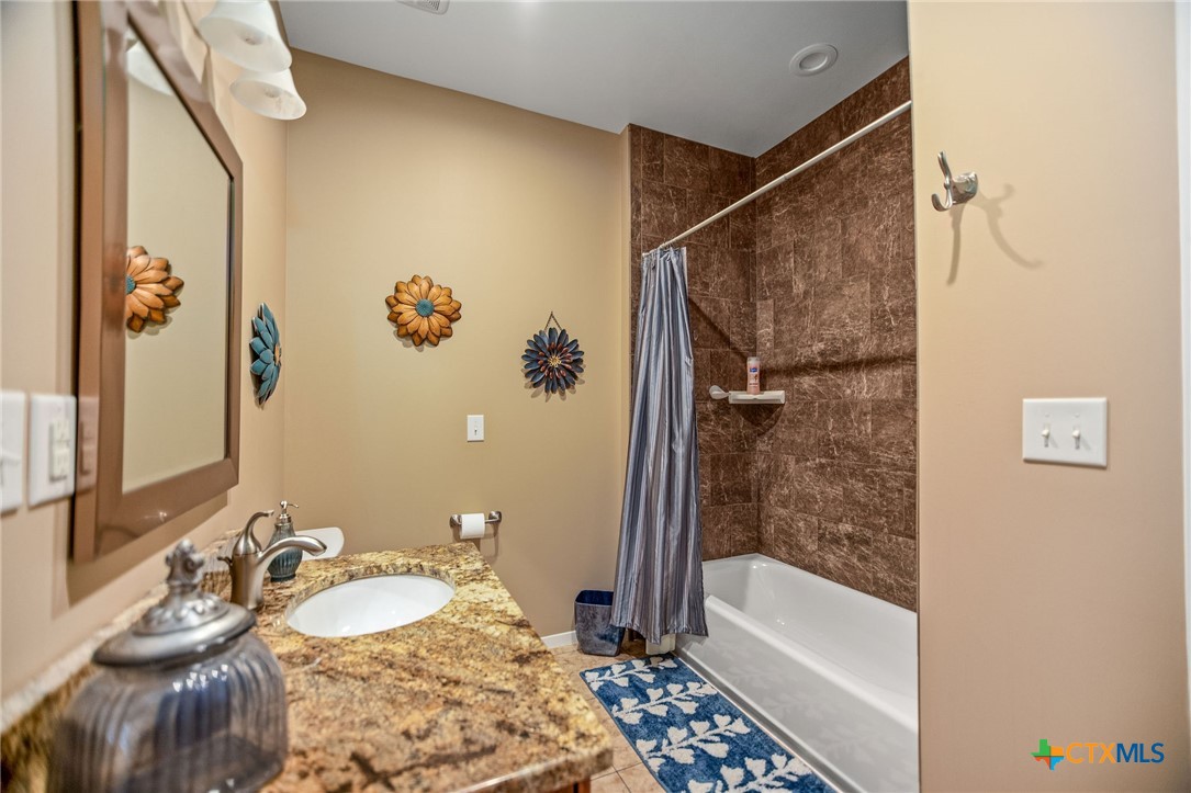 265 Coastal Oaks Loop Port O'Connor, TX 77982 - Photo 40 of 48 a bathroom with a tub a sink and a mirror