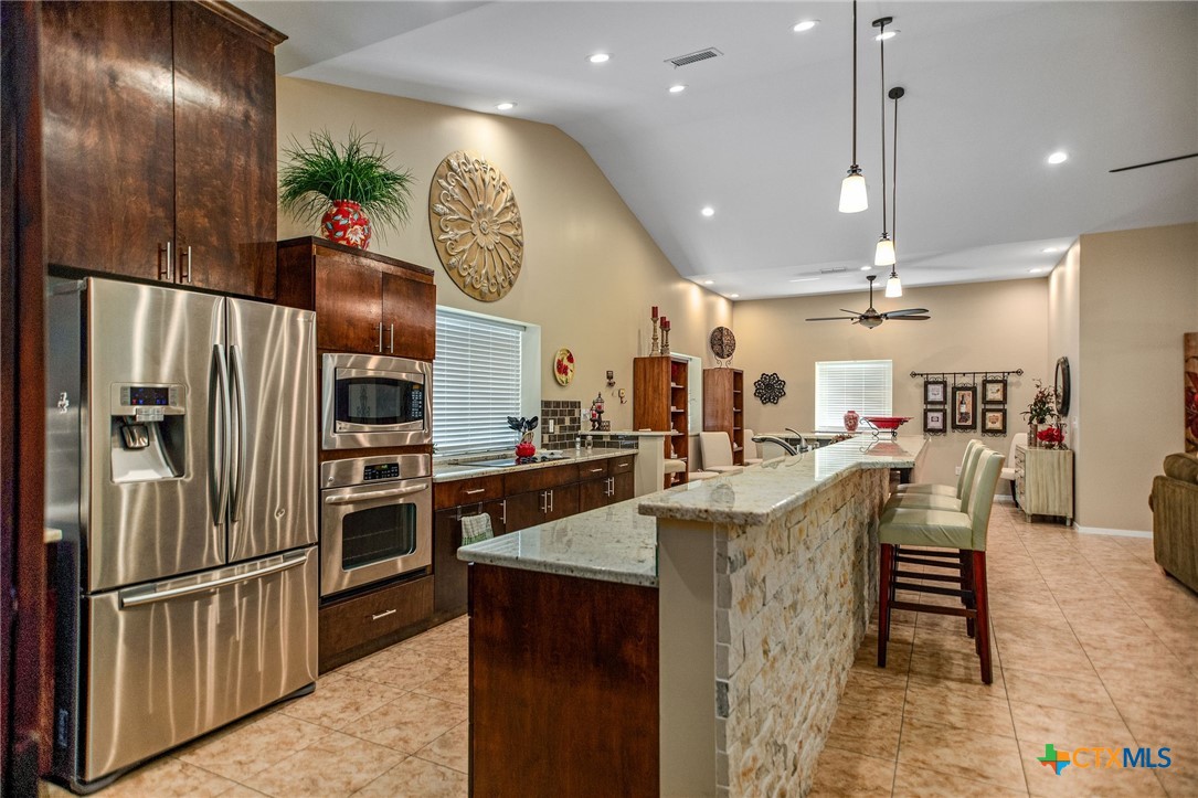 265 Coastal Oaks Loop Port O'Connor, TX 77982 - Photo 4 of 48 a kitchen with cabinets and stainless steel appliances