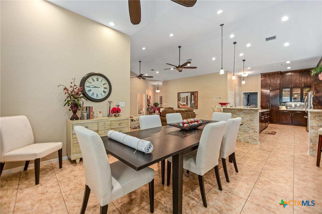 265 Coastal Oaks Loop Port O'Connor, TX 77982 - Photo 41 of 48 a view of a dining area with furniture and a clock