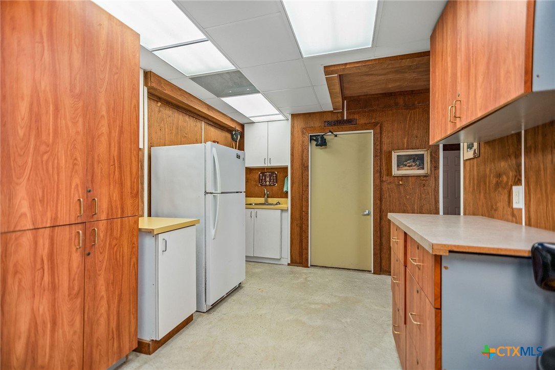 265 Coastal Oaks Loop Port O'Connor, TX 77982 - Photo 9 of 48 a view of a refrigerator in kitchen and a sink