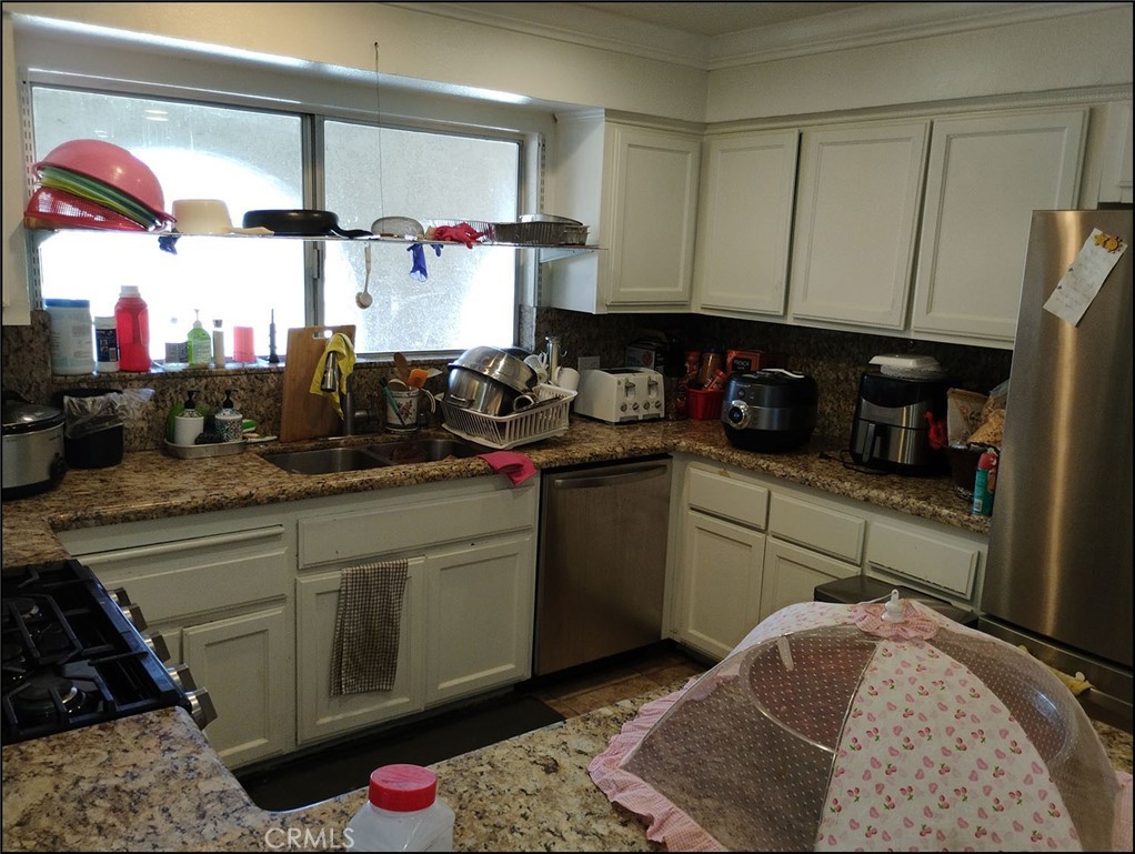 4077 Amador Road Phelan, CA 92371 - Photo 23 of 40 a kitchen with a sink cabinets and appliances