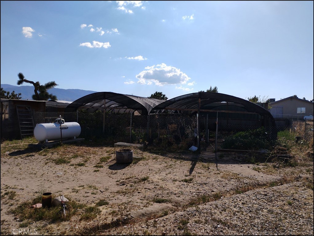 4077 Amador Road Phelan, CA 92371 - Photo 32 of 40 a backyard of a house with table and chairs