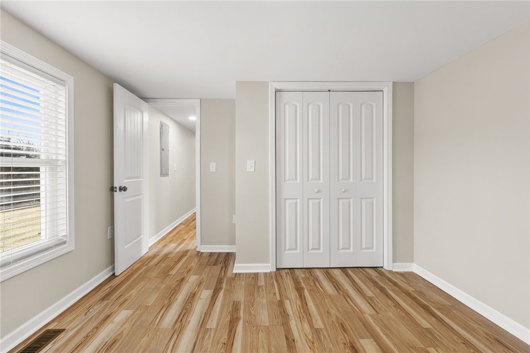 139 Davis Road Easley, SC 29640 - Photo 22 of 34 This spacious bedroom offers ample natural light and durable flooring, creating a comfortable living space.