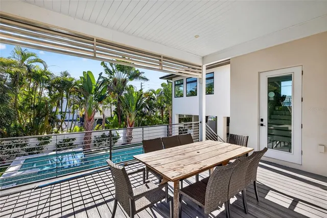 a living room with furniture a flat screen tv and a table
