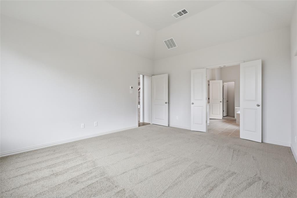 3737 Pitchfork Terrace Anna, TX 75409 - Photo 14 of 33 Spacious carpeted room featuring a vaulted ceiling and multiple white panel doors