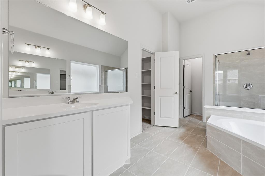 3737 Pitchfork Terrace Anna, TX 75409 - Photo 15 of 33 Modern bathroom featuring a single vanity with white cabinetry and a large mirror