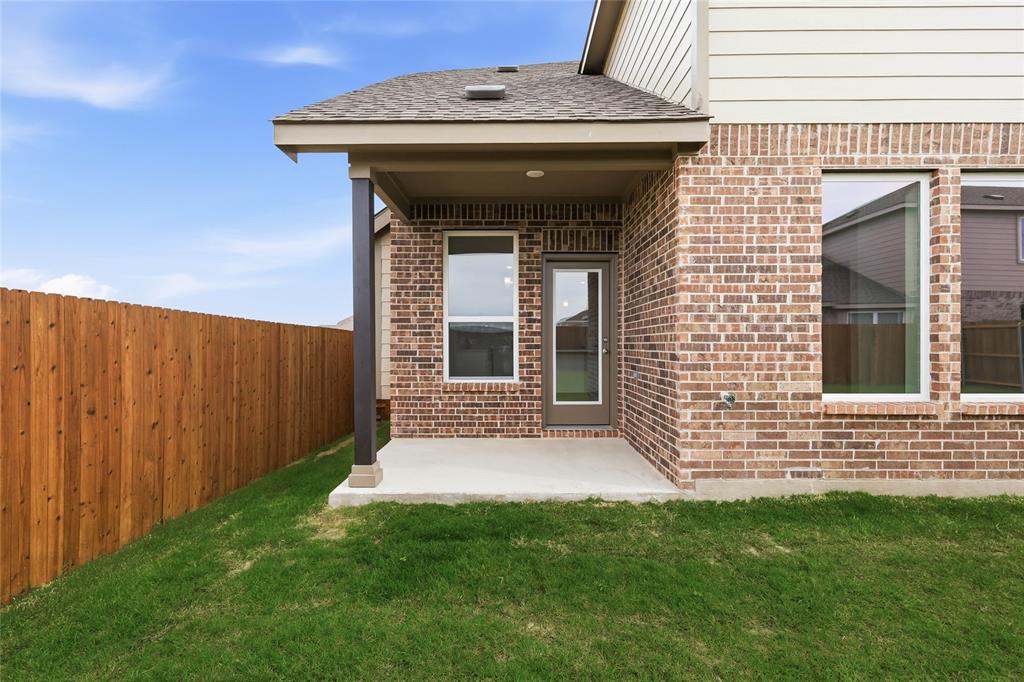 3737 Pitchfork Terrace Anna, TX 75409 - Photo 28 of 33 Covered patio with a concrete slab, brick exterior, and a private wood fence