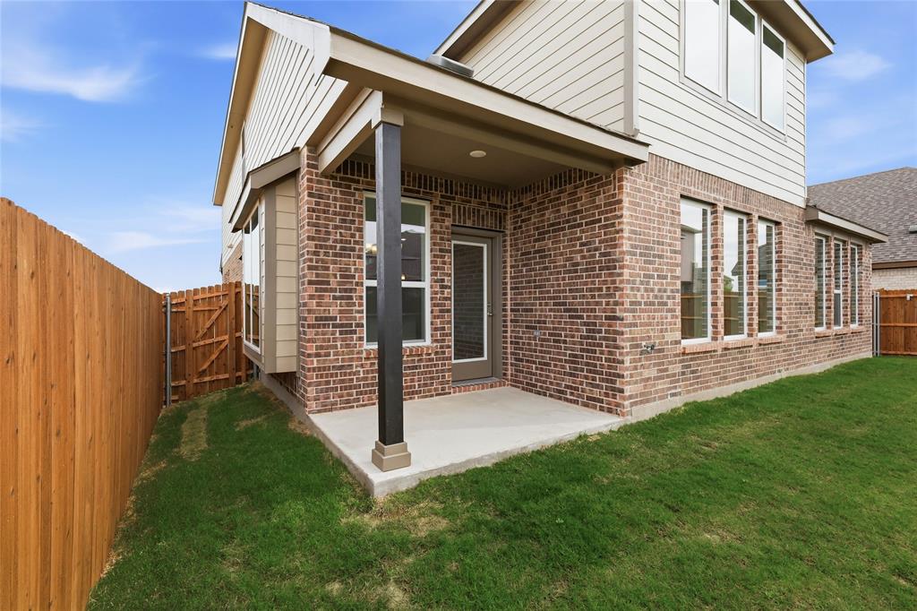 3737 Pitchfork Terrace Anna, TX 75409 - Photo 29 of 33 Brick exterior featuring a covered patio with concrete flooring, multiple window installations, and a privacy fence