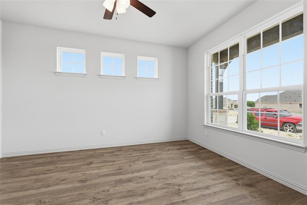 3737 Pitchfork Terrace Anna, TX 75409 - Photo 4 of 33 Spacious room featuring wood-finish flooring, white baseboards, and bright white walls
