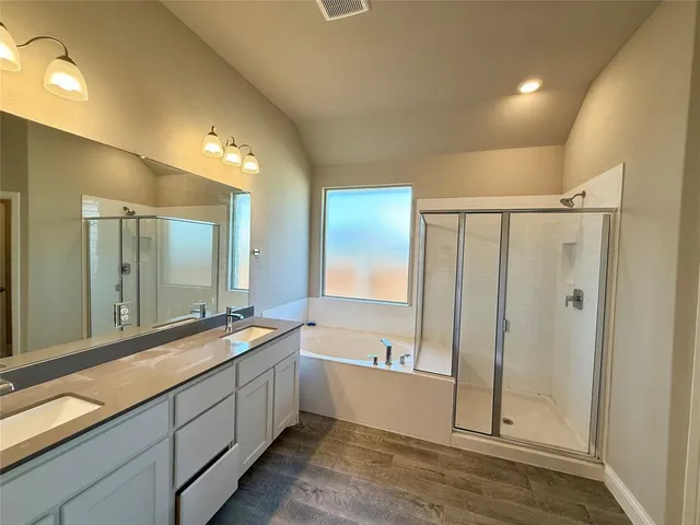 a large bathroom with a large tub and shower