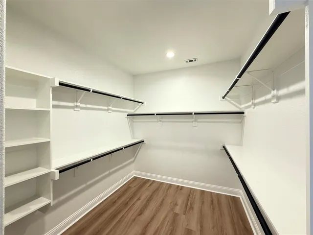 a bathroom with a double vanity sink a mirror and a bathtub