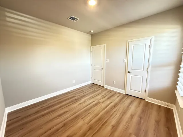 a view of walk in closet with wooden floor
