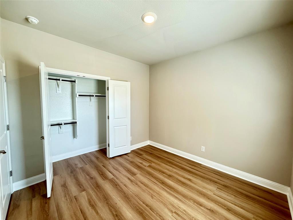 3476 Evergreen Way Midlothian, TX 76065 - Photo 16 of 22 Unfurnished bedroom with light wood finished floors and a closet