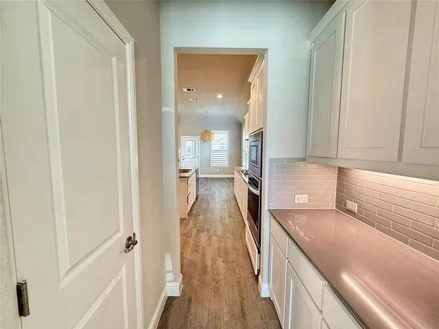 a view of a kitchen from the hallway