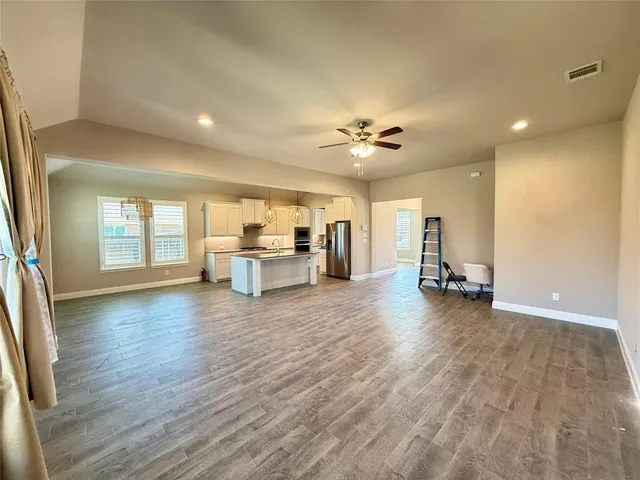 a view of livingroom with hardwood floor and a ceiling fan