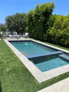 a view of a swimming pool with a yard