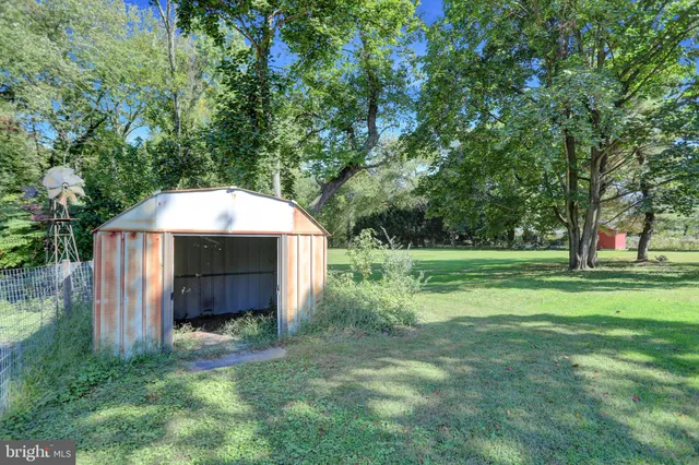 a kitchen with stainless steel appliances granite countertop wooden floors and wooden cabinets