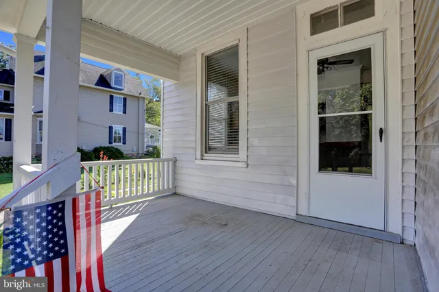 a view of an empty room with a fireplace and a window