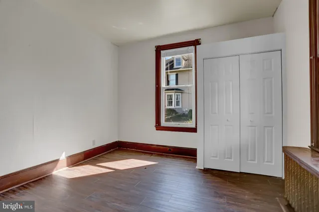 wooden floor in an empty room with a window