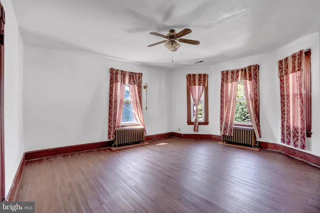 an empty room with wooden floor and closet