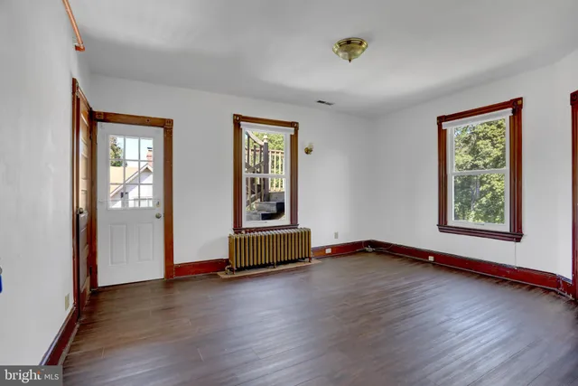 a view of room with window wooden floor and a ceiling fan