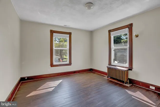 a view of hallway with wooden floor
