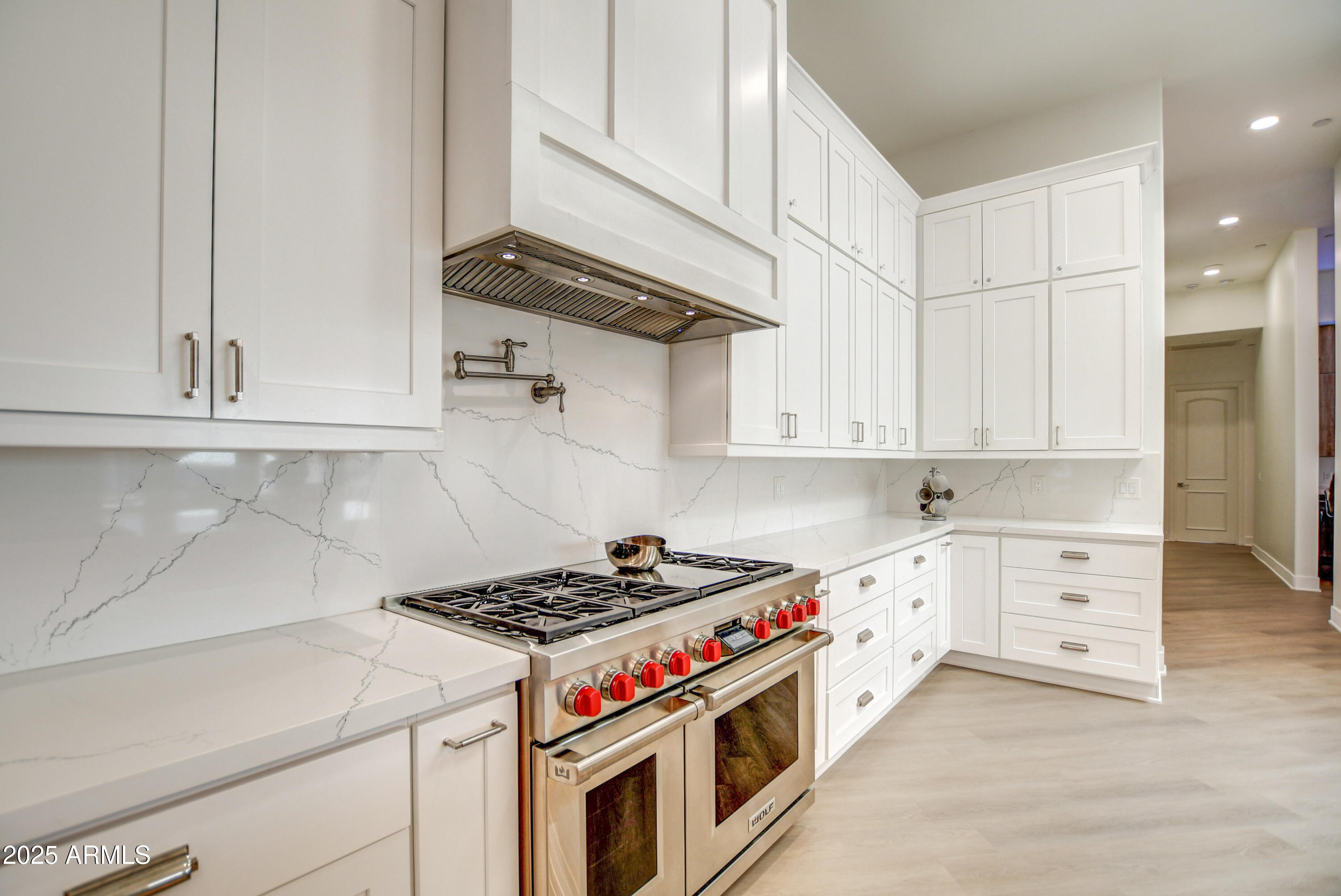 10651 East Cactus Road Scottsdale, AZ 85259 - Photo 36 of 126 a kitchen with stainless steel appliances granite countertop a stove and a white cabinets