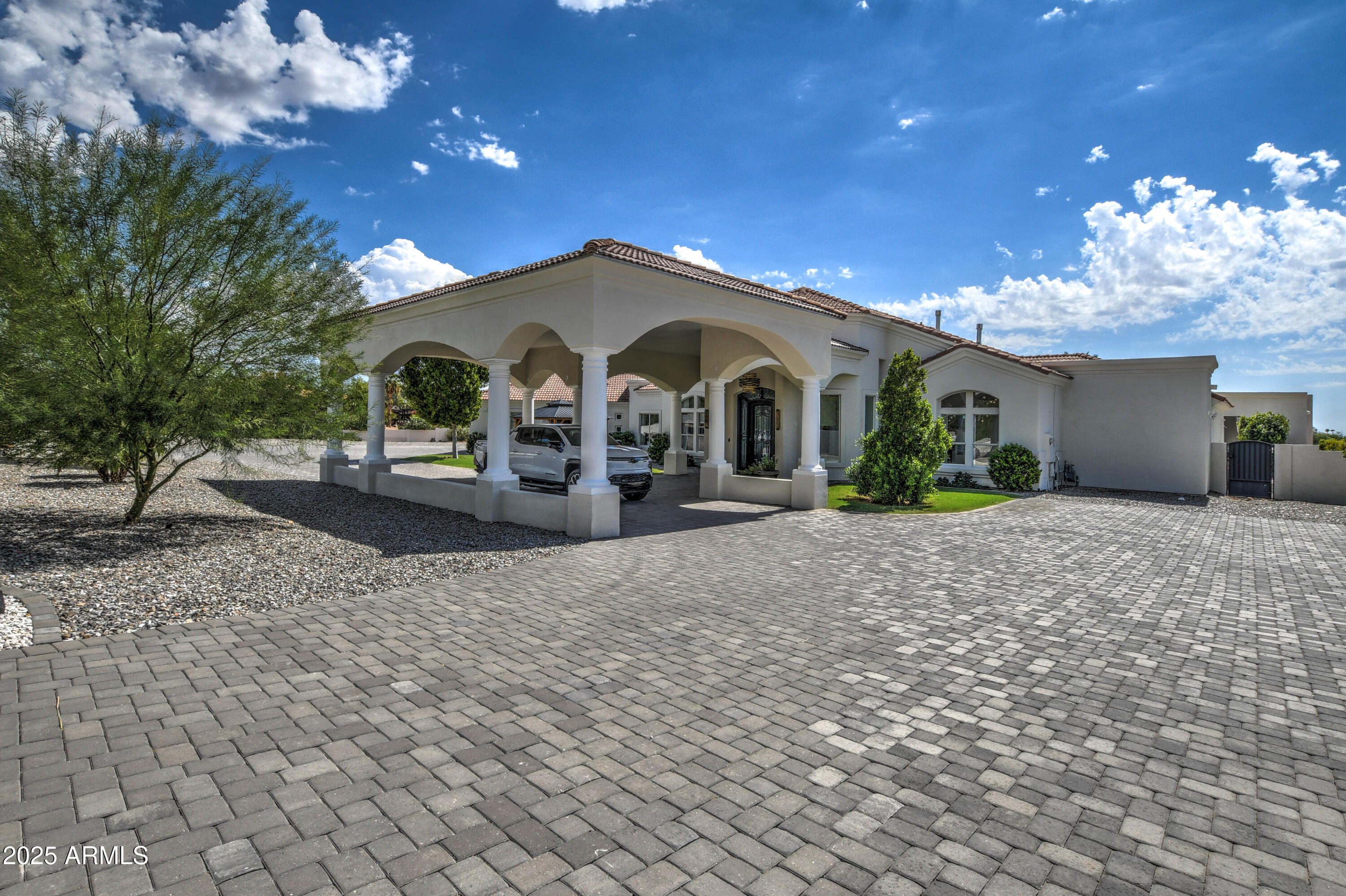 10651 East Cactus Road Scottsdale, AZ 85259 - Photo 4 of 126 a front view of a house with a yard and potted plants