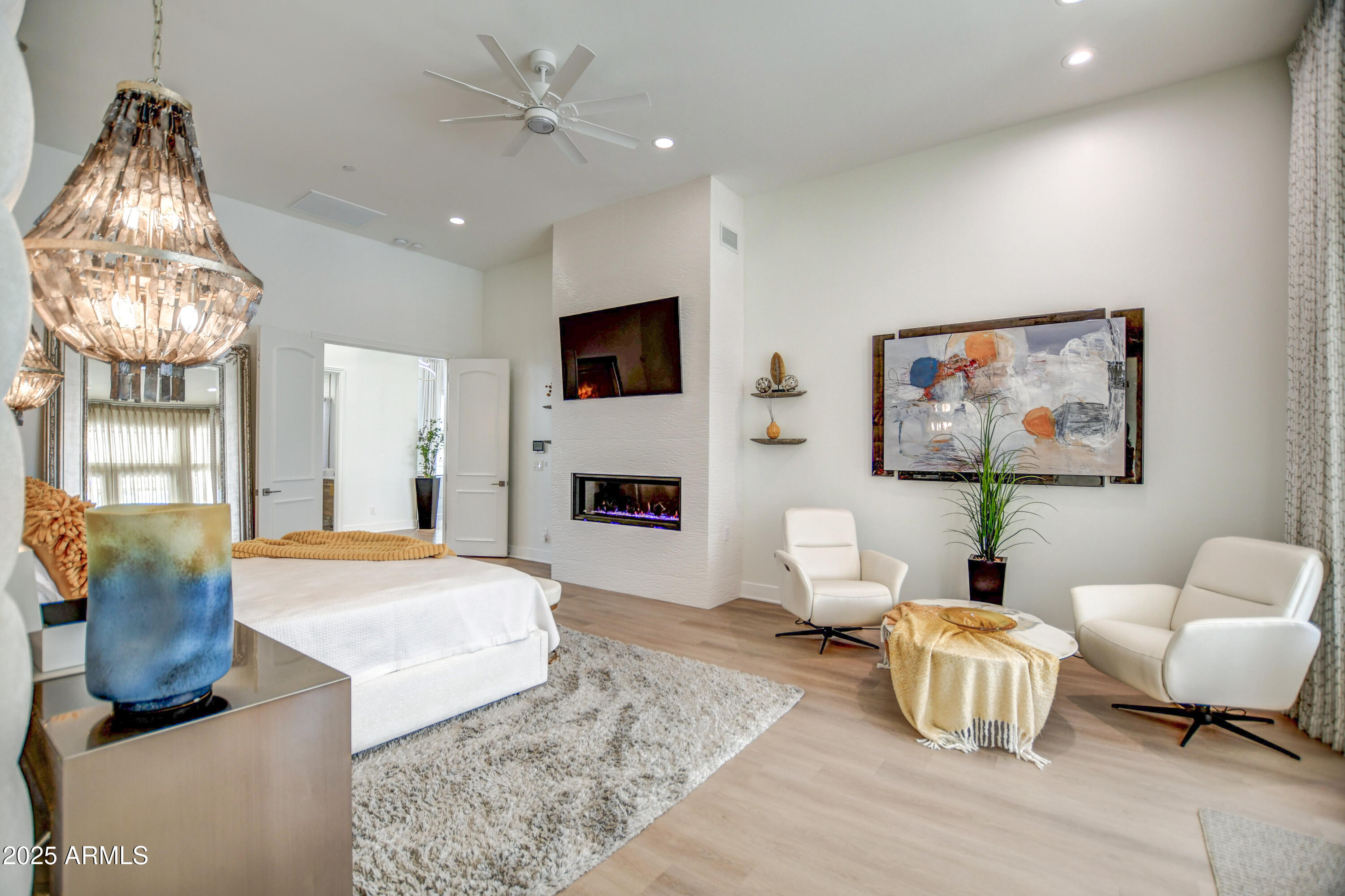 10651 East Cactus Road Scottsdale, AZ 85259 - Photo 62 of 126 a living room with furniture a fireplace and a chandelier
