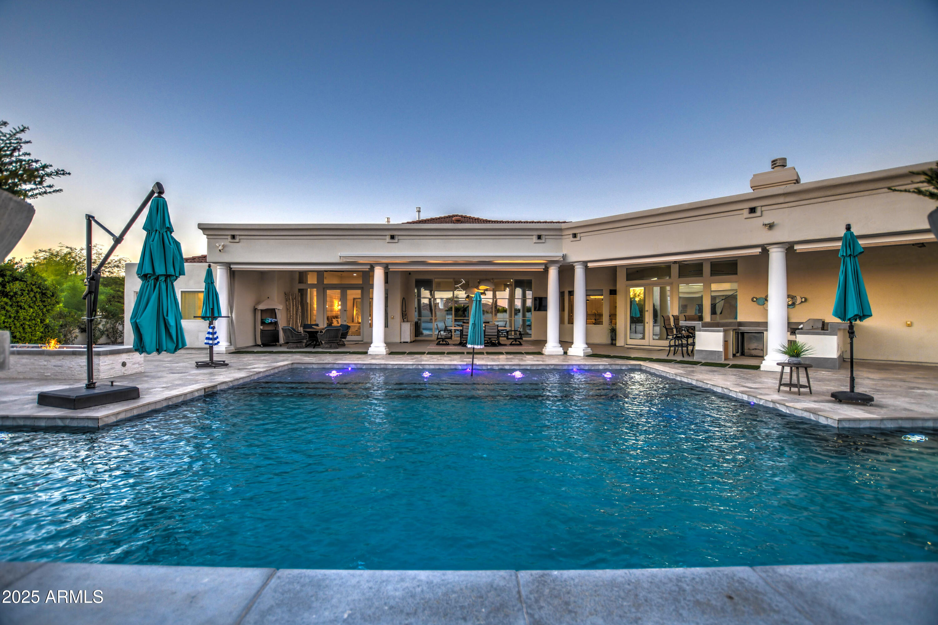 10651 East Cactus Road Scottsdale, AZ 85259 - Photo 95 of 126 a view of pool with a table and chairs under an umbrella