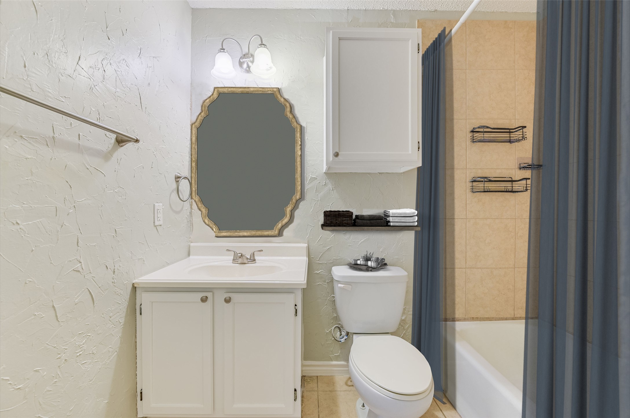 526 Cutty Trail, Unit B Lakeway, TX 78734 - Photo 9 of 10 Bathroom featuring a white vanity with integrated sink, an ornate framed mirror, and a full-size bathtub with tiled surround