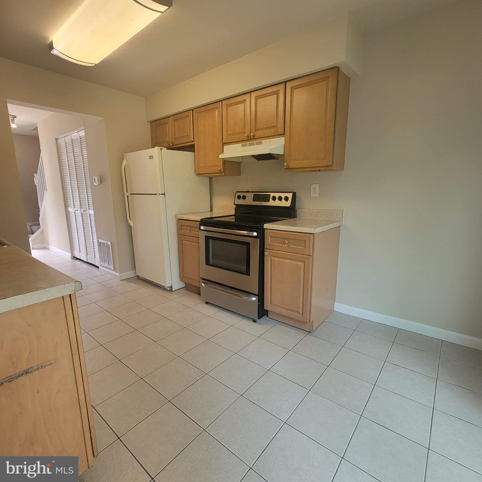 3381 Ryon Court Waldorf, MD 20601 - Photo 7 of 12 a kitchen with a stove a refrigerator and cabinets