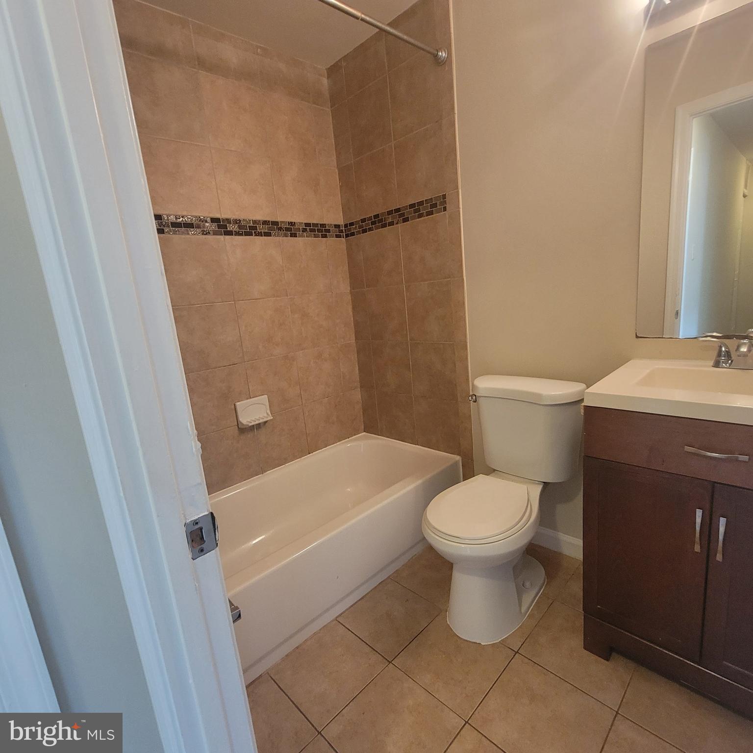 3381 Ryon Court Waldorf, MD 20601 - Photo 10 of 12 a white toilet sitting next to a bath tub