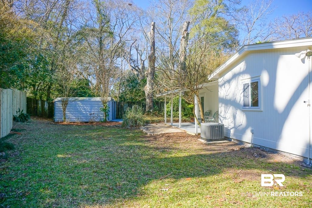 4159 Rebecca Road Mobile, AL 36609 - Photo 14 of 19 View of yard featuring a patio area, a fenced backyard, and central AC unit