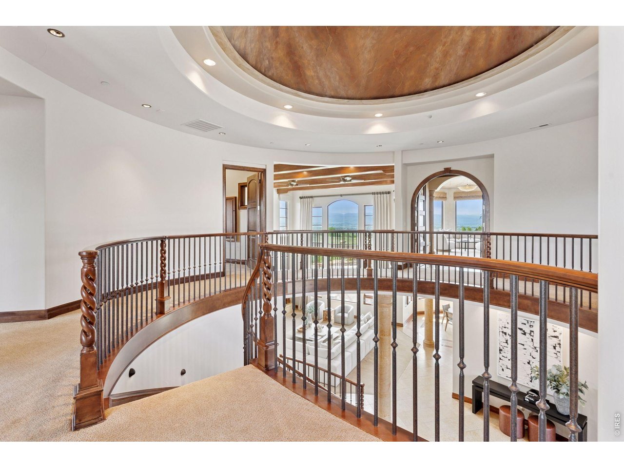 6541 Legend Ridge Trail Niwot, CO 80503 - Photo 22 of 45 Grand curved three-story staircase with custom iron balusters, alder wood molding and a circular domed ceiling with custom faux marble paint.