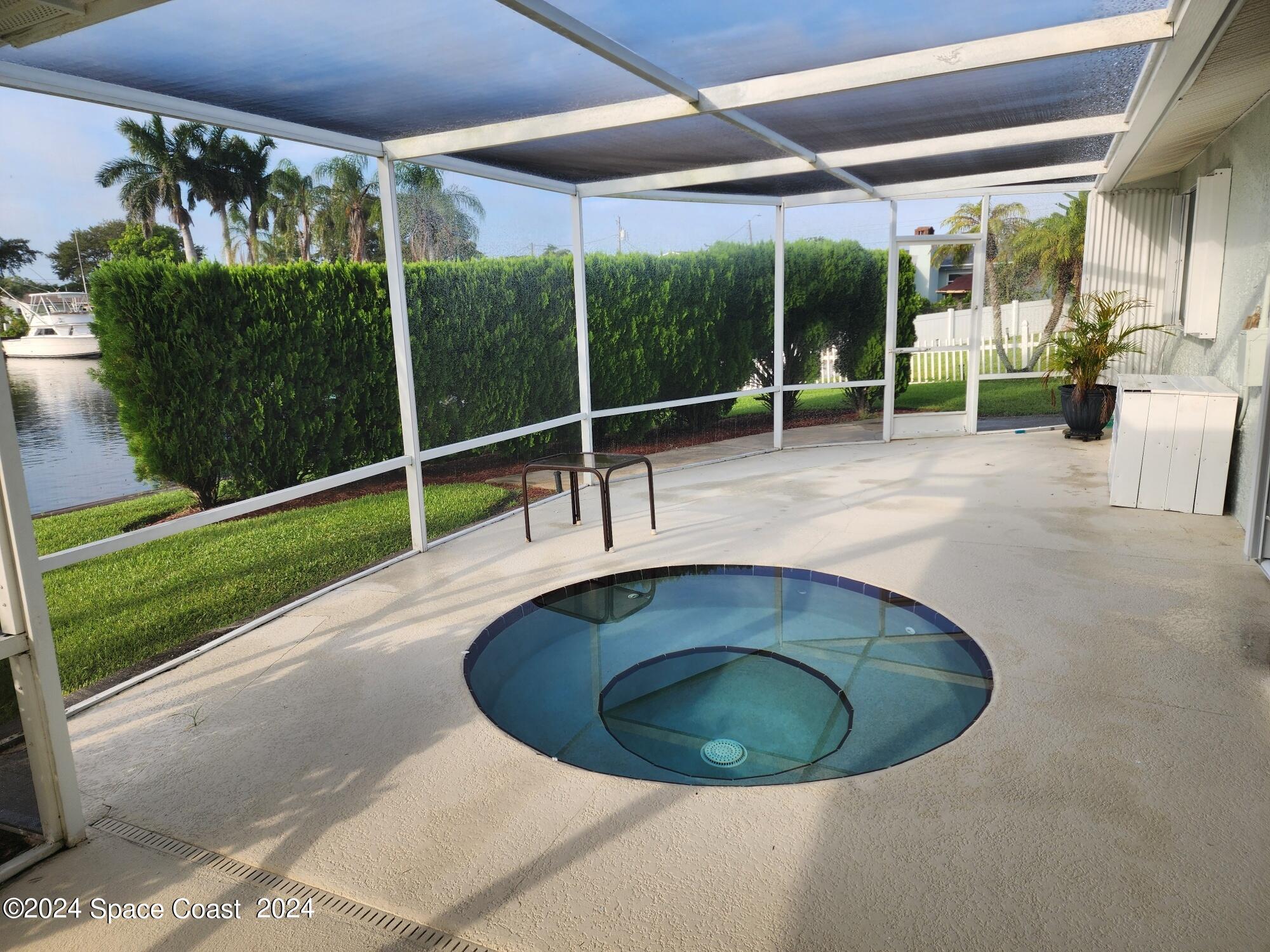 1725 Reef Court Merritt Island, FL 32952 - Photo 21 of 26 a view of a swimming pools under an umbrella
