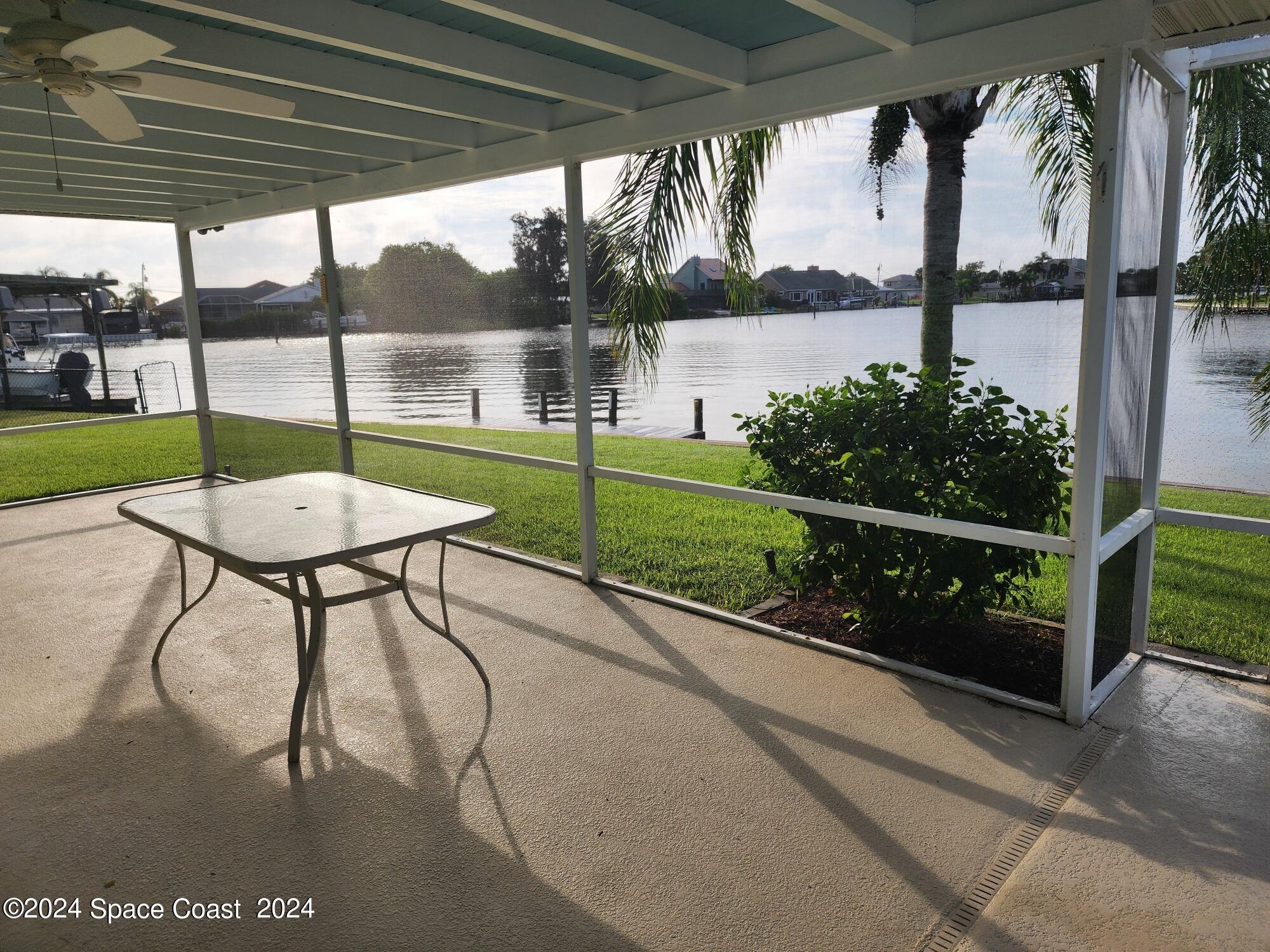 1725 Reef Court Merritt Island, FL 32952 - Photo 22 of 26 a view of a porch with furniture and a yard