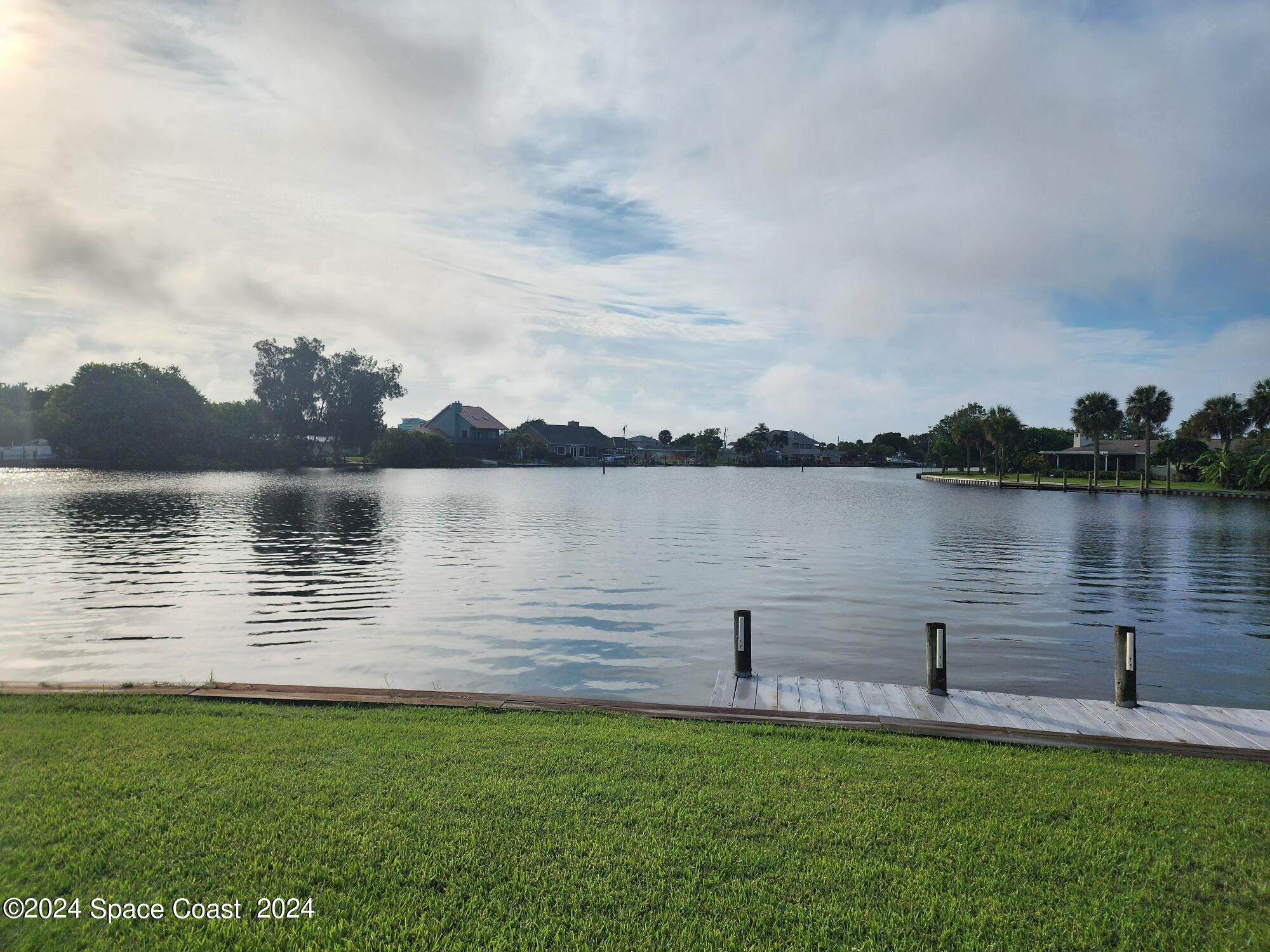 1725 Reef Court Merritt Island, FL 32952 - Photo 25 of 26 a view of a lake with a big yard