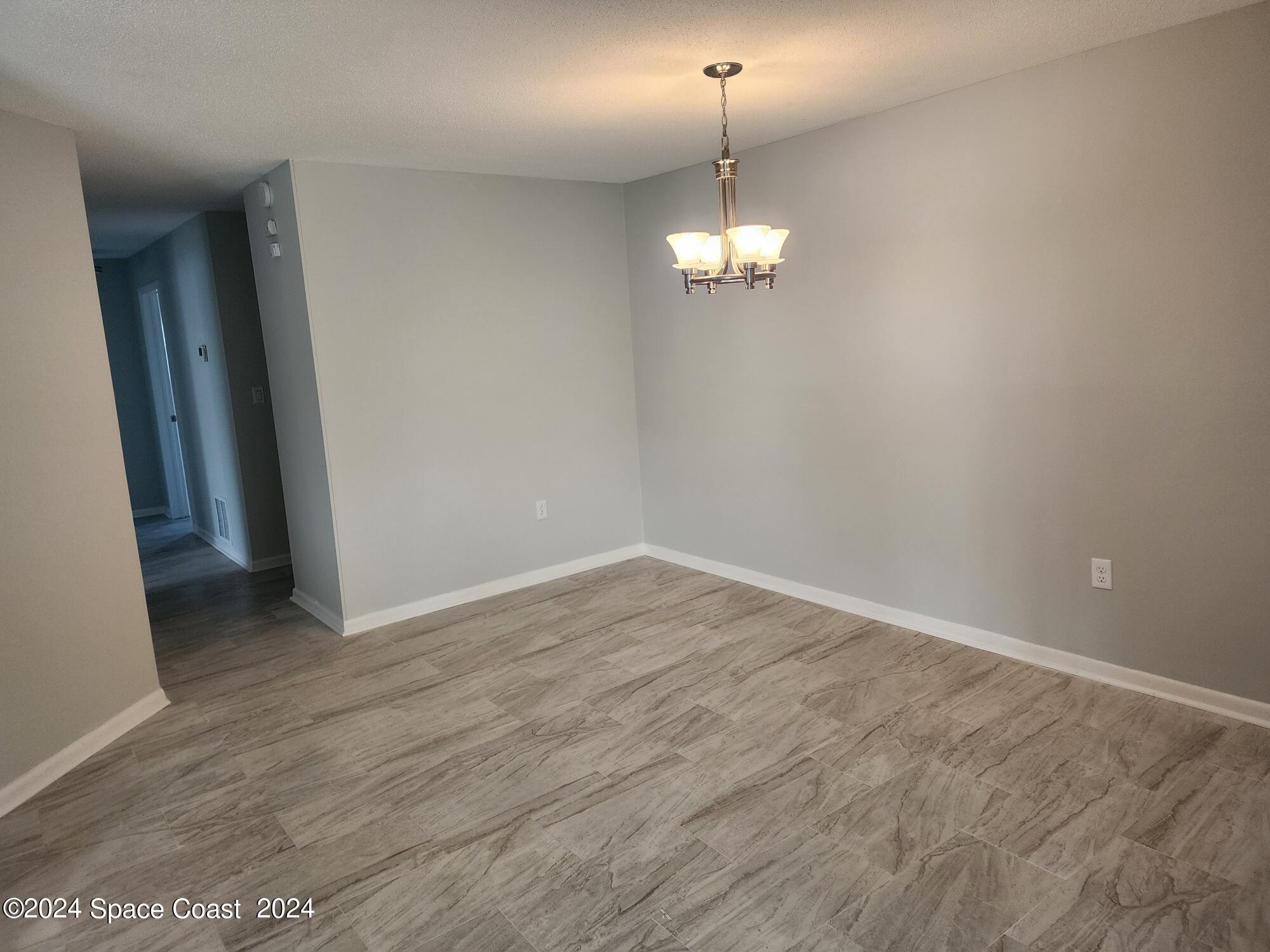 1725 Reef Court Merritt Island, FL 32952 - Photo 6 of 26 a view of empty room with wooden floor