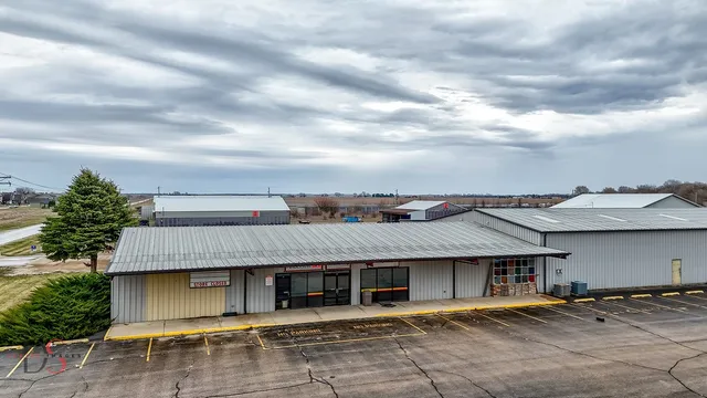 a front view of a house with a garden and trees
