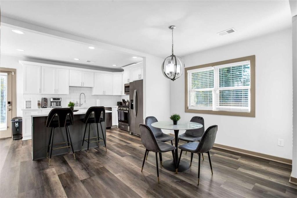 128 Nathan Road Southwest Atlanta, GA 30331 - Photo 11 of 36 a view of a dining room with furniture window and wooden floor