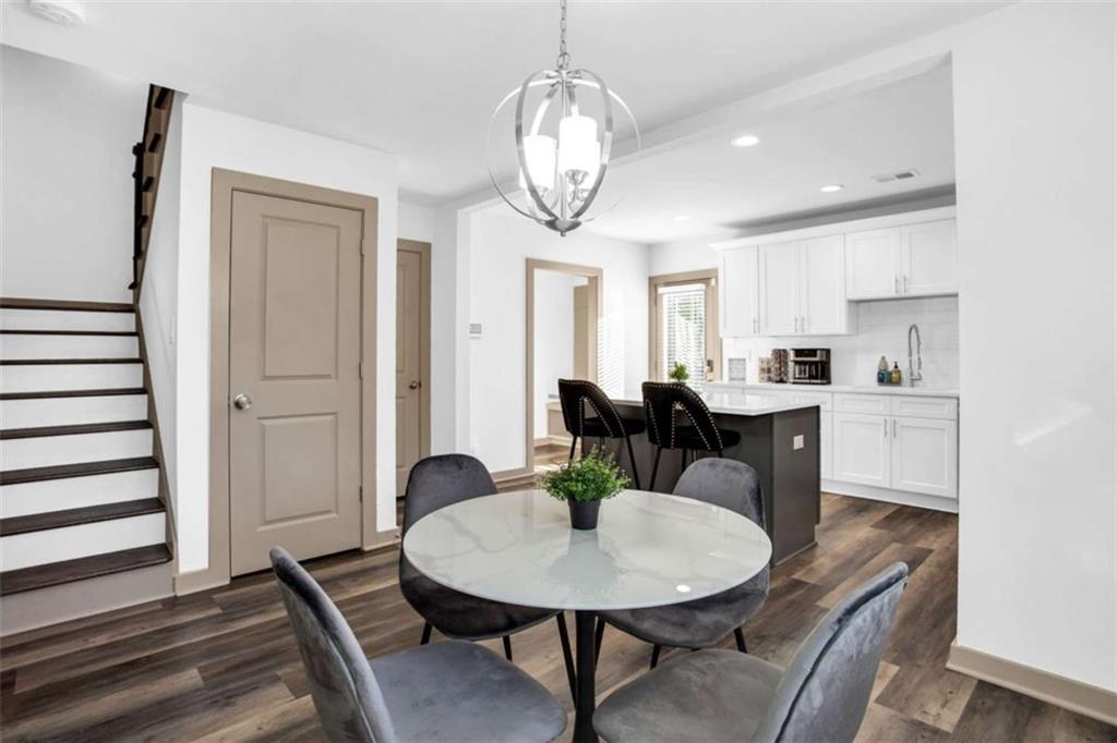 128 Nathan Road Southwest Atlanta, GA 30331 - Photo 12 of 36 a view of a dining room with furniture wooden floor and a chandelier