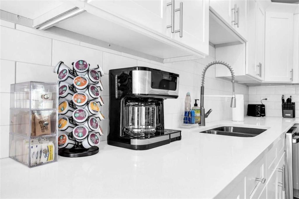 128 Nathan Road Southwest Atlanta, GA 30331 - Photo 15 of 36 a kitchen with lots of appliances and a sink