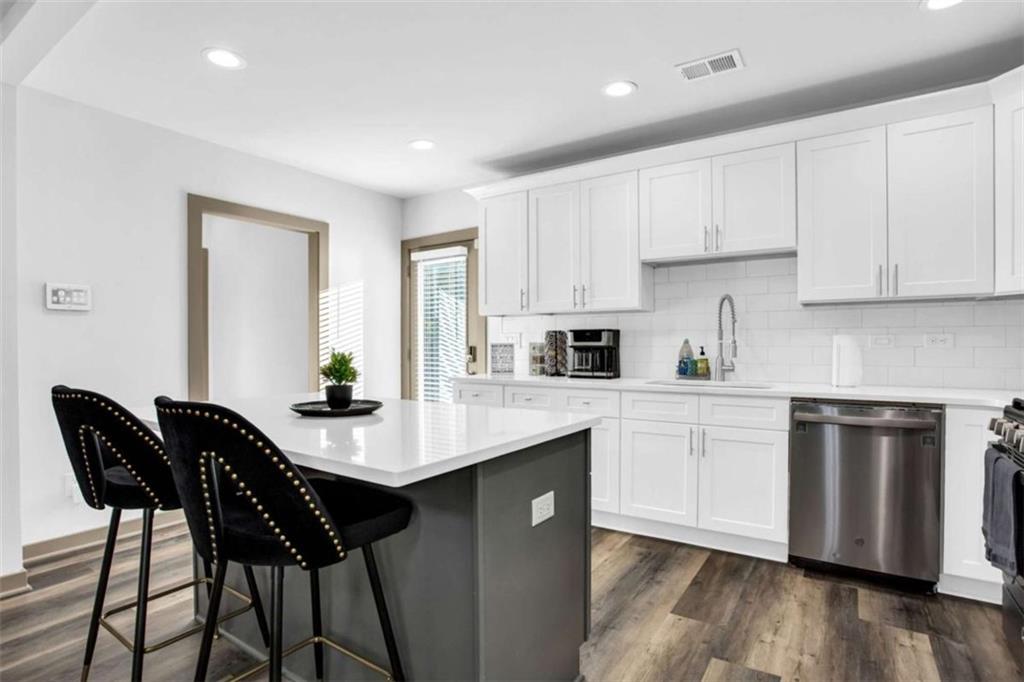 128 Nathan Road Southwest Atlanta, GA 30331 - Photo 16 of 36 a kitchen with a sink cabinets and wooden floor