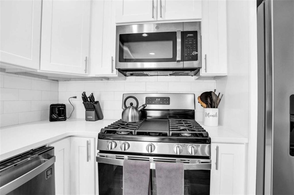 128 Nathan Road Southwest Atlanta, GA 30331 - Photo 17 of 36 a kitchen with stainless steel appliances granite countertop a stove and a microwave