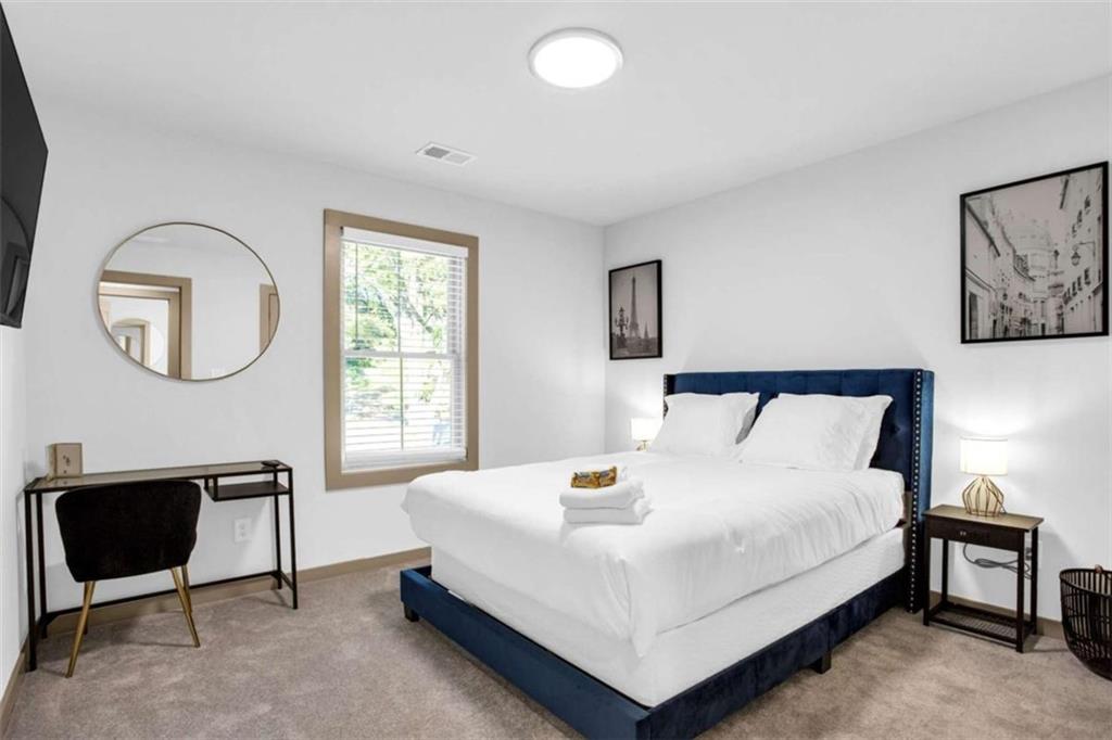 128 Nathan Road Southwest Atlanta, GA 30331 - Photo 23 of 36 a large bed sitting in a bedroom next to a window