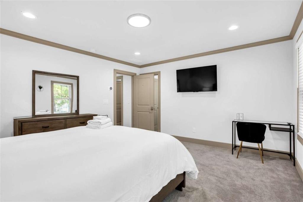 128 Nathan Road Southwest Atlanta, GA 30331 - Photo 29 of 36 a bedroom with a bed and a flat screen tv